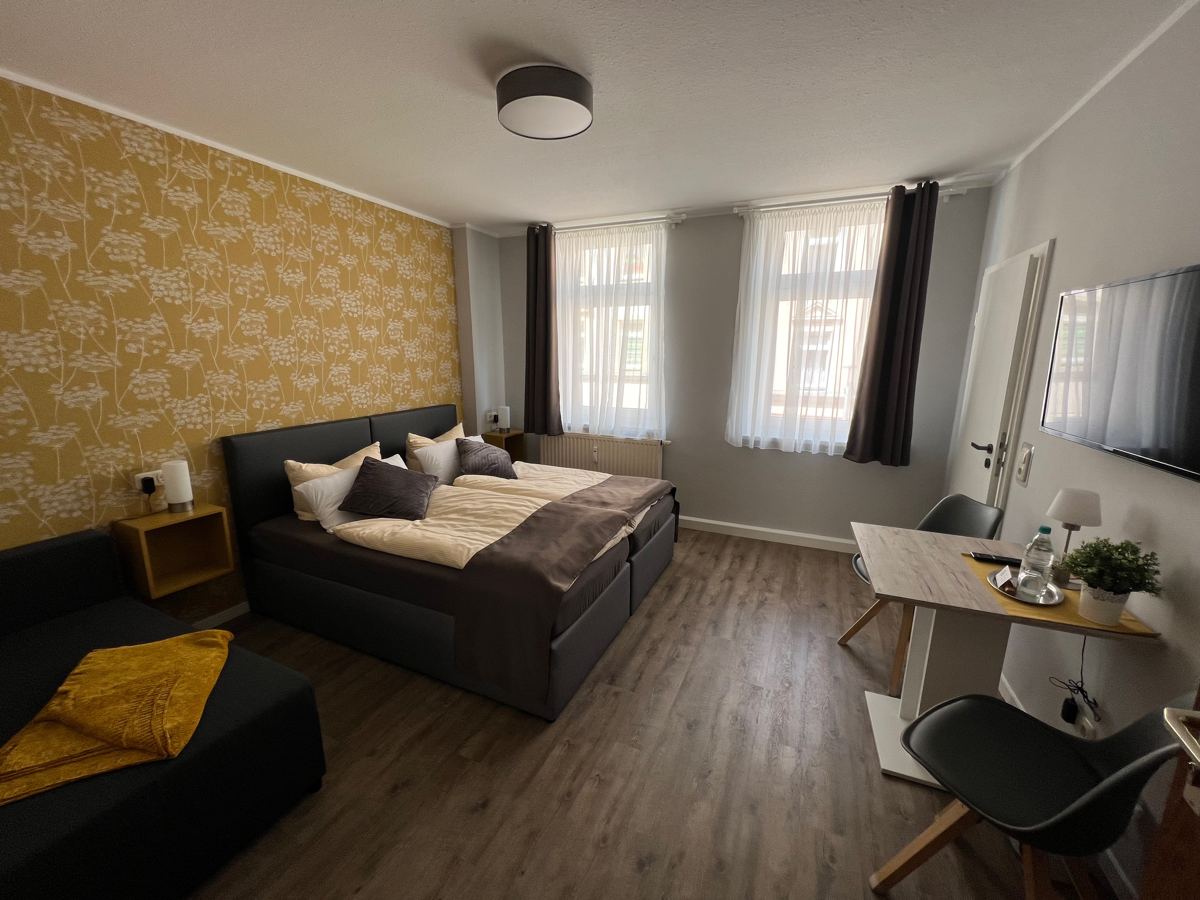 Superior double room with wooden floor and sofa